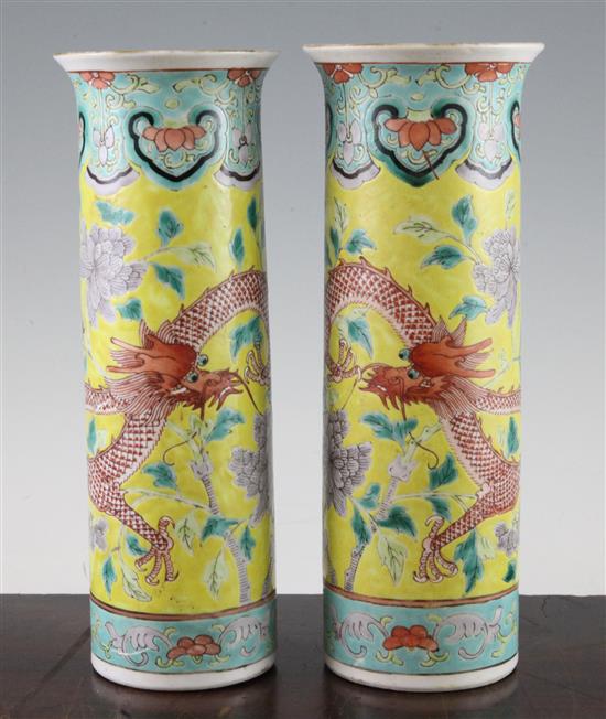 A pair of Chinese famille rose yellow ground sleeve vases, Kangxi mark, late 19th century, 26cm